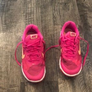 Pink and coral Nike tennis shoes